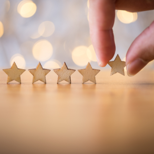 Hand arranging shining gold star decor pieces